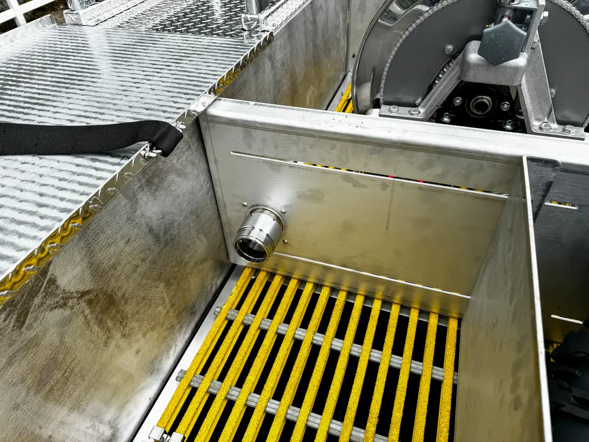 Top bay close-up showing cylindrical component and adjacent plumbing.